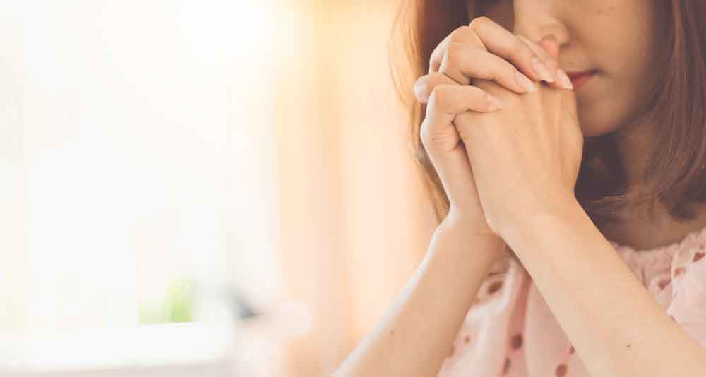 Beautiful woman hands praying to god.
