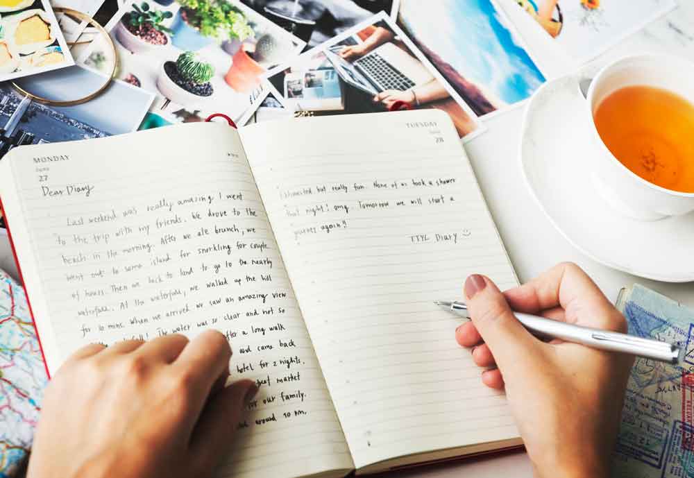 Closeup of hands writing a journal.