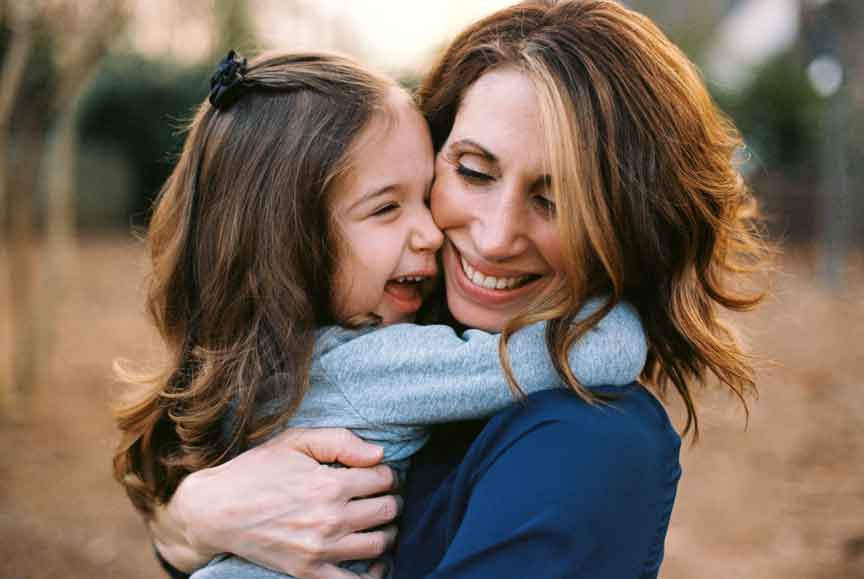 A girl hugs her mum with gratitude and thankful for her love.