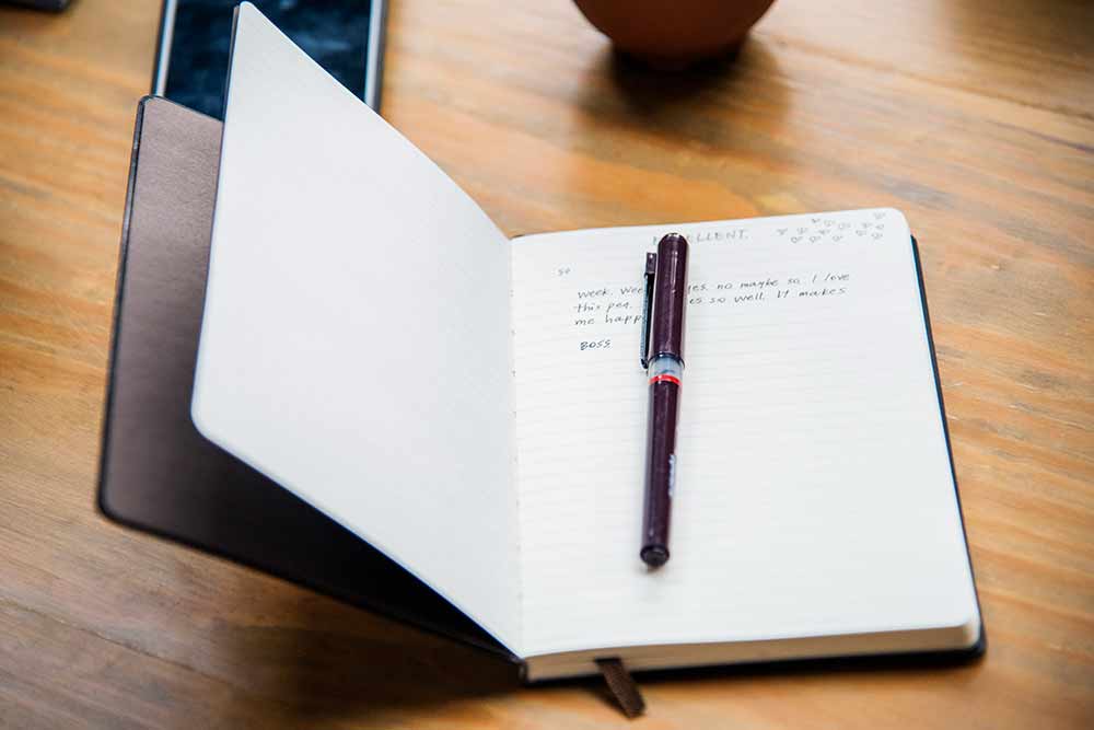 Open leather notebook on a table.