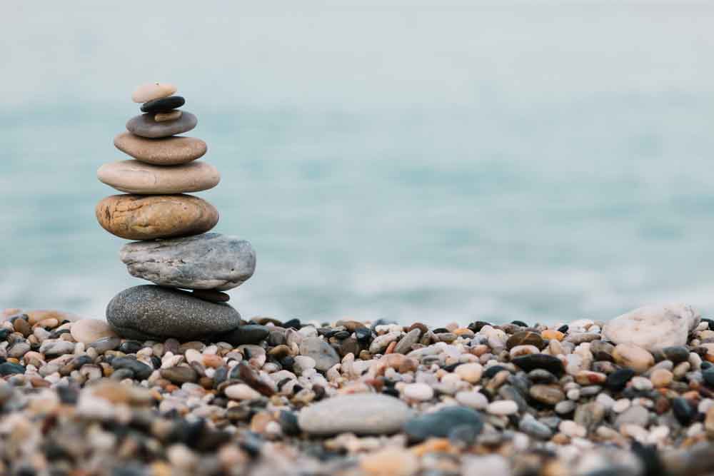 Stack of peaceful and calm pebble stones on ocean.